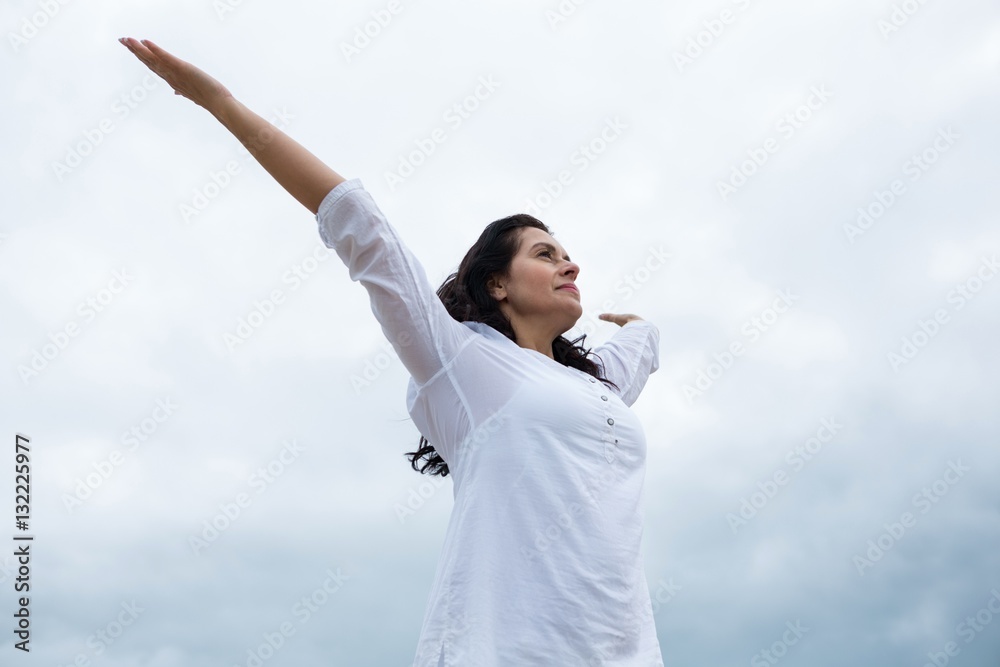 Happy woman standing with arms outstretched Happy woman standing with arms outstretched