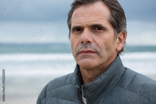 Portrait of serious man on beach