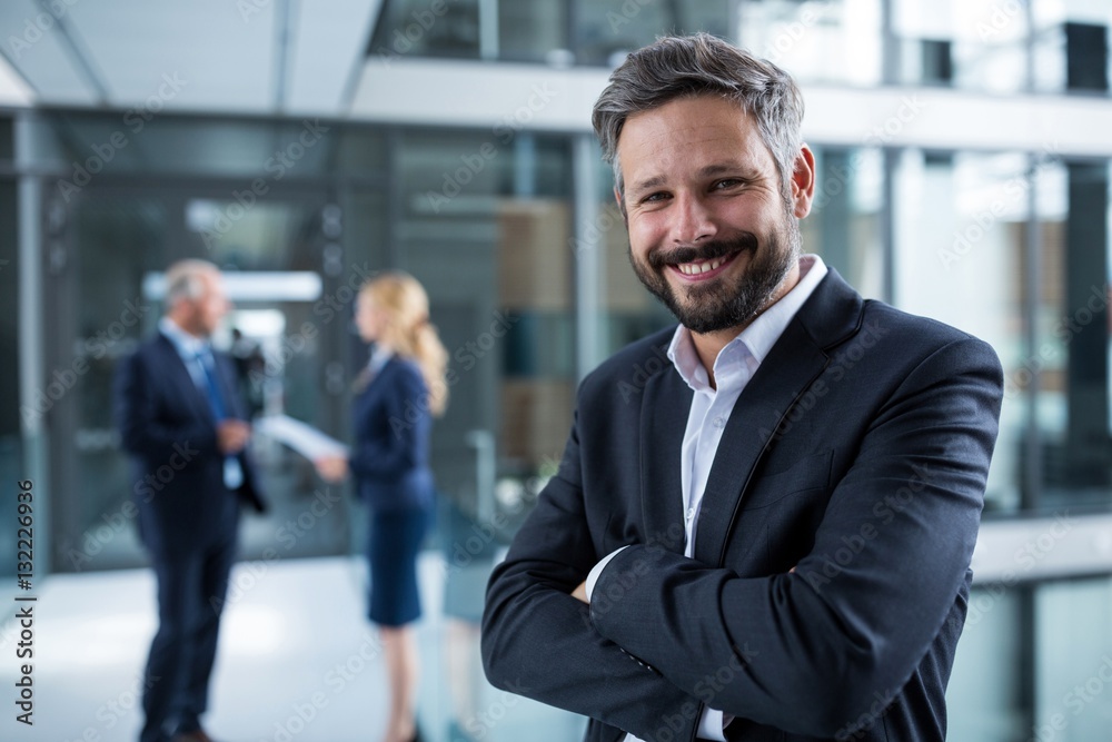 Portrait of businessman standing with arms crossed