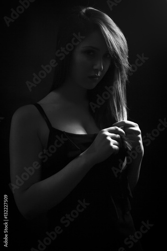 Low key portrait of beautiful young woman. Monochrome, Black background