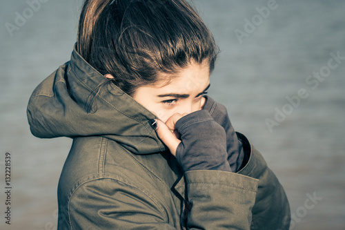 Outdoor portrait of a  teenage girl wearing khaki parka © Androlia
