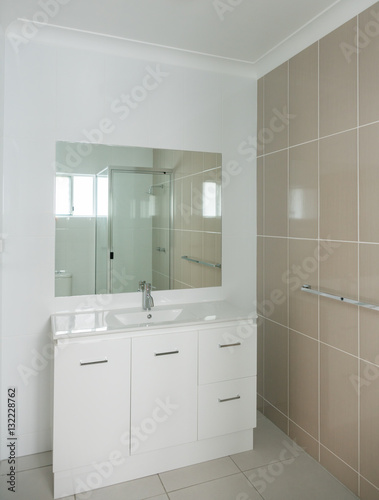 New compact ensuite bathroom with ensuite  shower and tiled wall