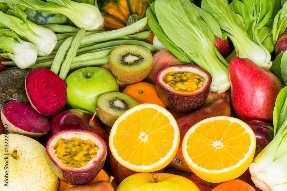 Closeup orange slice with various fresh fruits and vegetables for eating healthy Closeup orange slice with various fresh fruits and vegetables for eating healthy