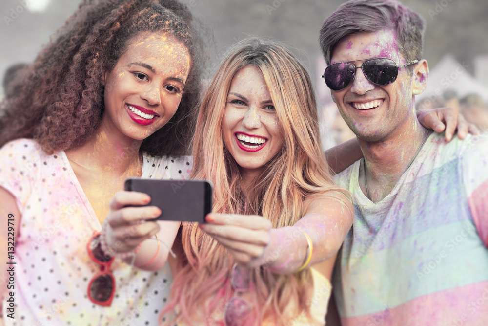 Friends with colored clothes taking selfie Friends with colored clothes taking selfie