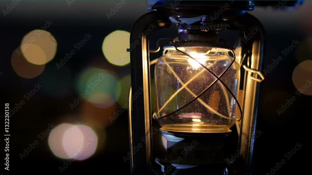 Paraffine Kerosene lantern on a background of defocused colored lights. Paraffine Kerosene lantern on a background of defocused colored lights.