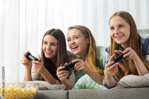 Teenage girls playing a video game