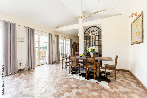 Spacious dining room with rustic tiles