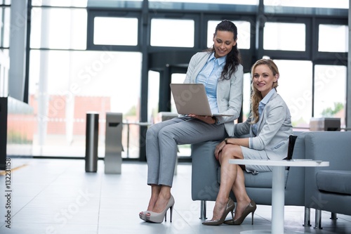 Businesswomen sitting with laptop