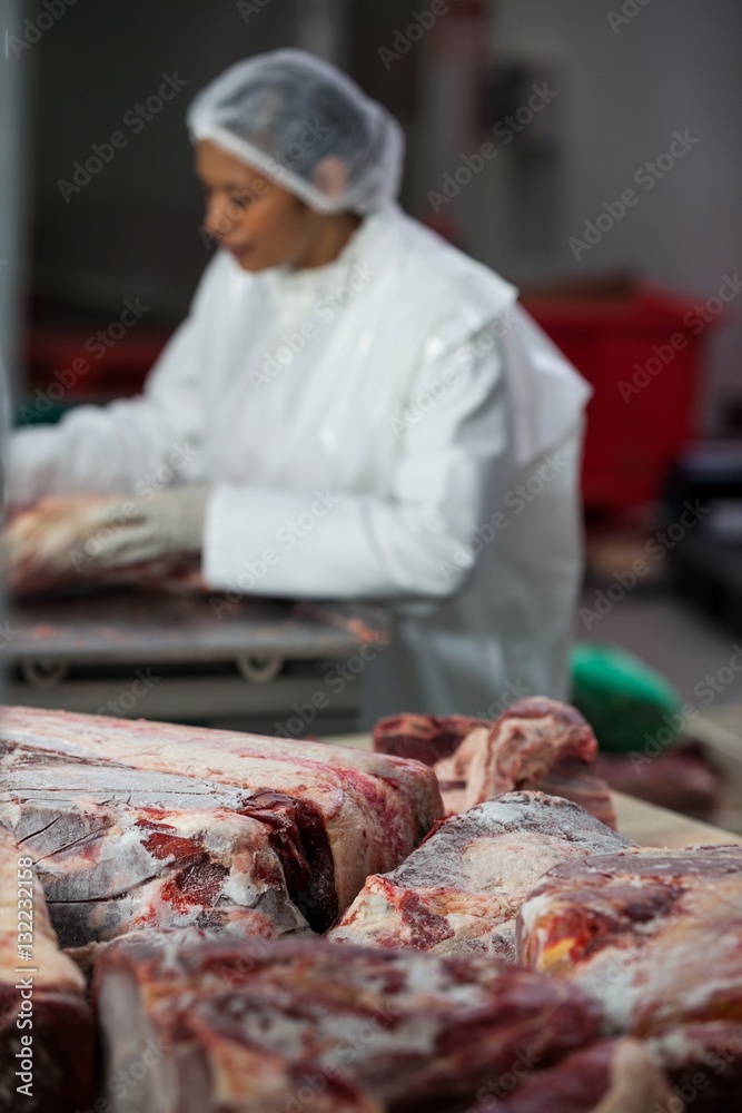 Close-up of raw meat on worktop at meat factory