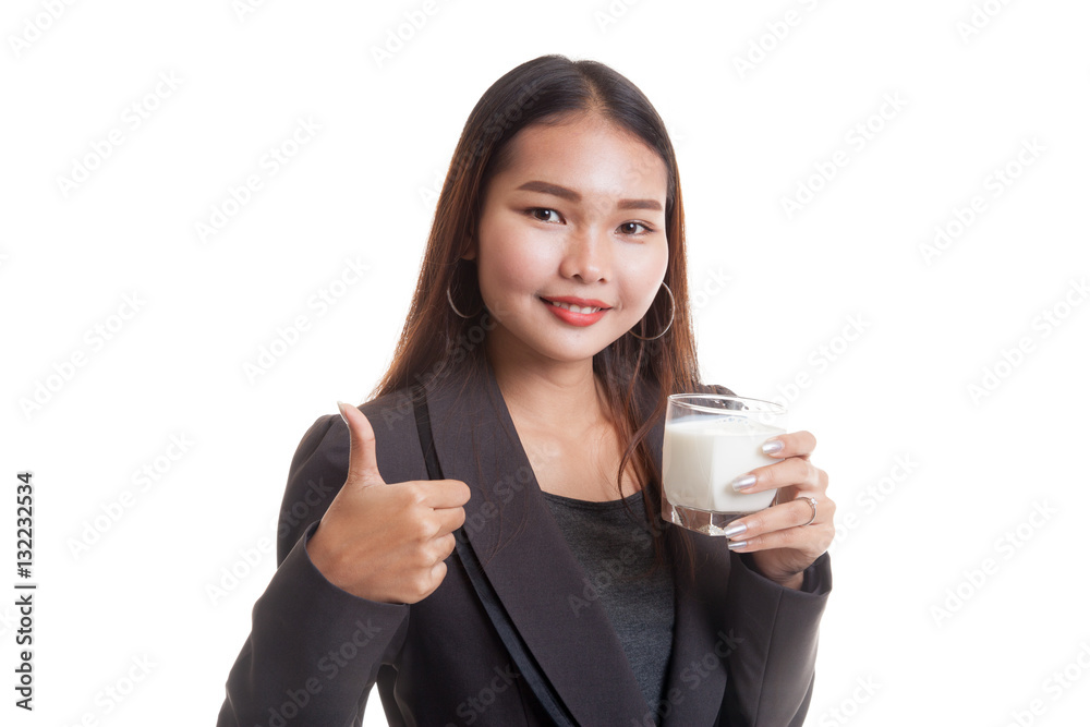 Healthy Asian woman drinking a glass of milk thumbs up. Healthy Asian woman drinking a glass of milk thumbs up.