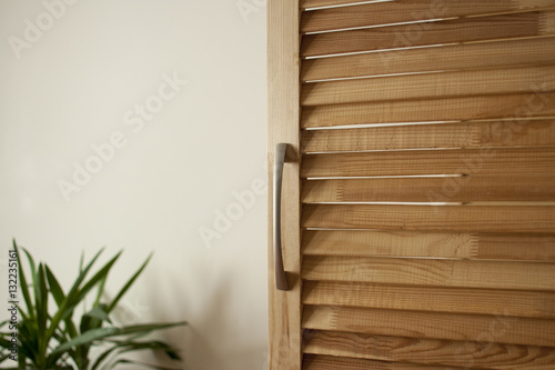 Interior details. The wooden door of the pines with slats and ch