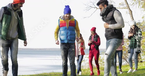 Young People Group Camping In Forest, Man Play Football, Woman Messaging Online, Mix Race Friends Group Outdoors Autumn Park Slow Motion 60