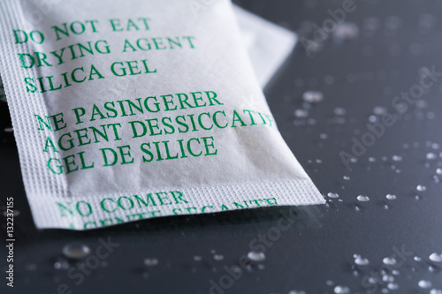 Desiccant or silica gel on background with water drops