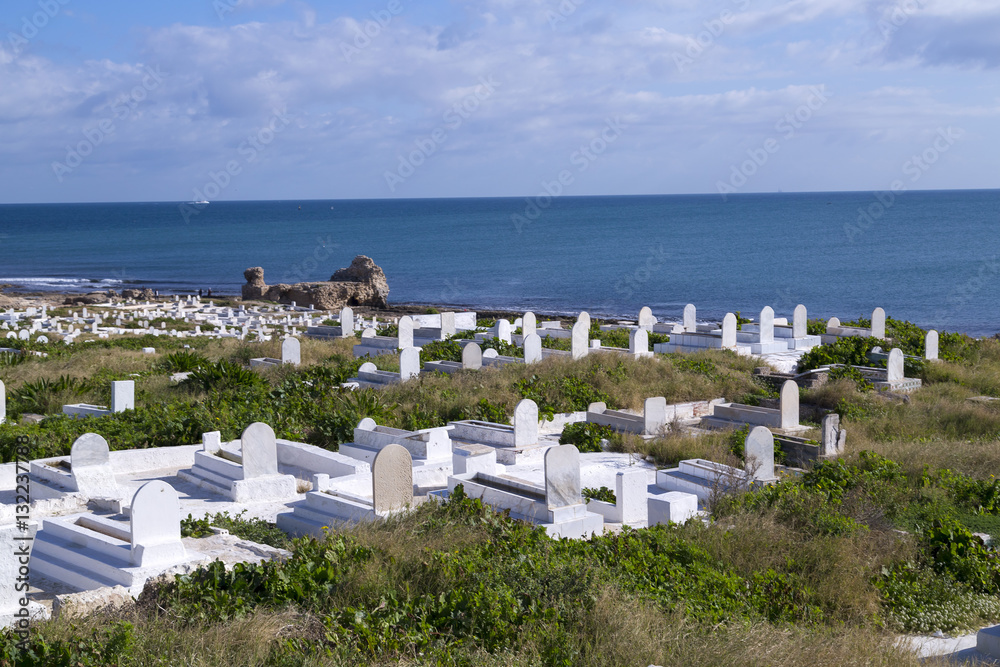 View from the coastal town of Mahdia in Mahdia Governorate of Tunisia, eastern Mediterranean coast with ruins of Fatimid Caliphate and graveyard.
