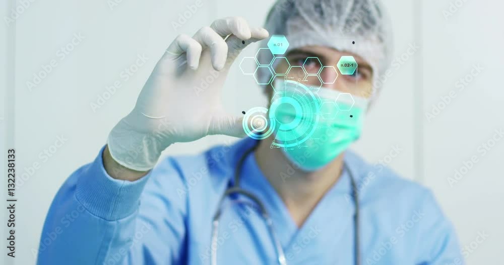 A physician, surgeon, examines a technological digital holographic plate represented the patient's body, the heart lungs, muscles, bones. Concept: Futuristic medicine, the human body, and the future.