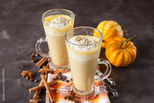 pumpkin latte in a glass on a table, selective focus