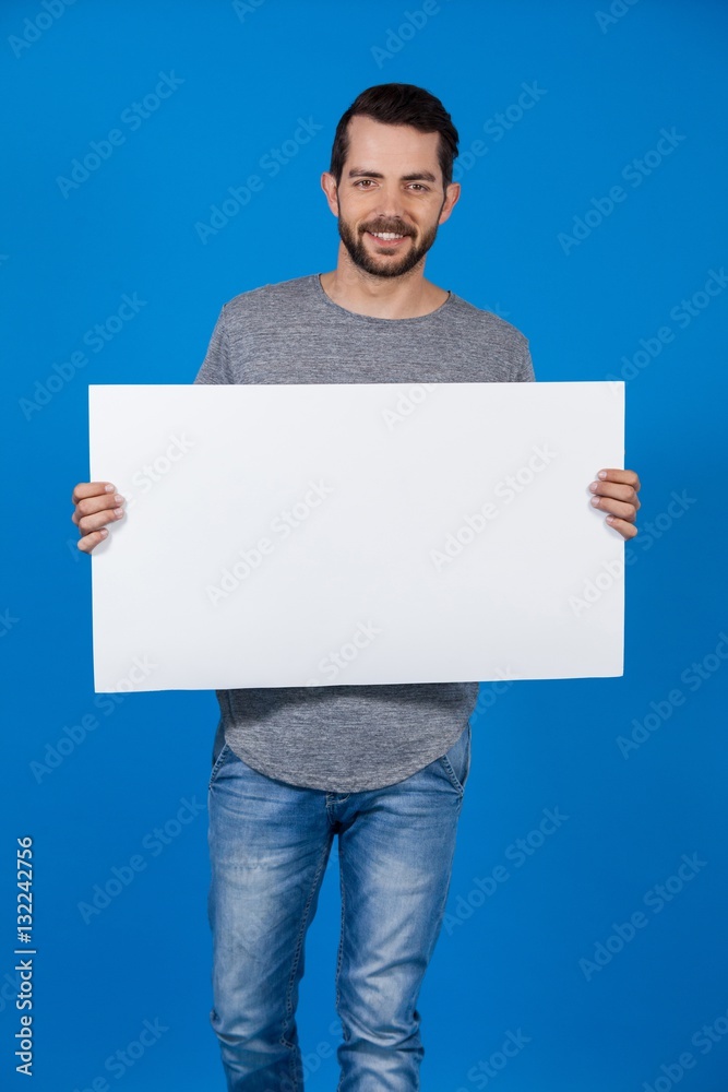Handsome man holding a blank placard Handsome man holding a blank placard