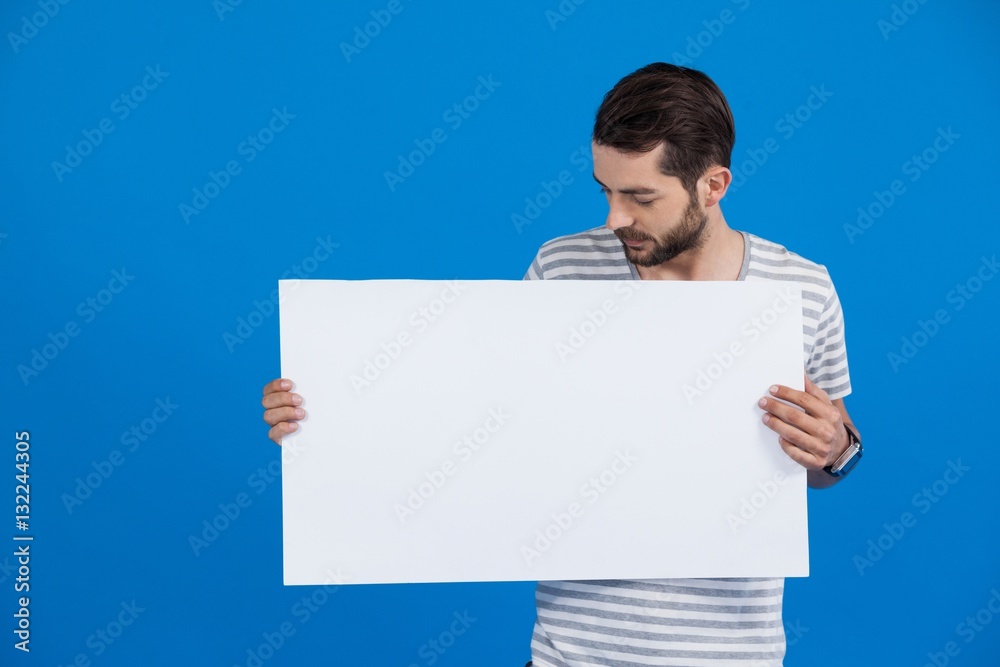 Handsome man holding a blank placard Handsome man holding a blank placard