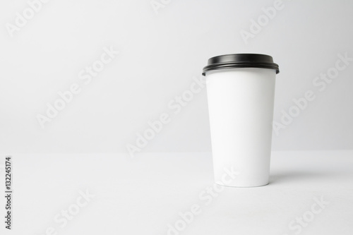 White paper cup with a black cap mockup