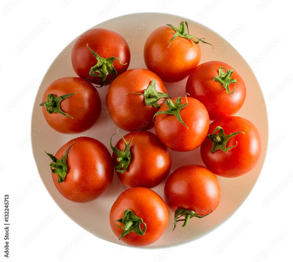 Red tomatoes on a plate isolated background top view Red tomatoes on a plate isolated background top view