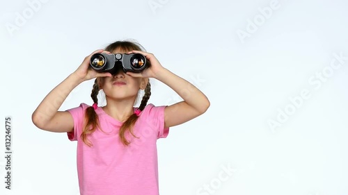 Little child girl looking through binoculars