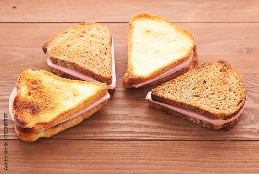 triangular sandwiches on wooden table