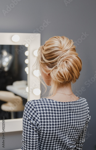 Close up detail of french twist hairstyle, back rear view at hairdresser salon