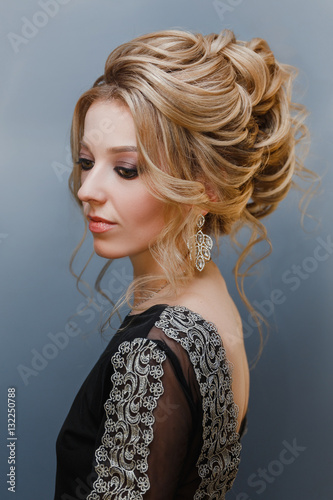 Beautiful woman with evening make-up, jewelry earrings and hairstyle portrait