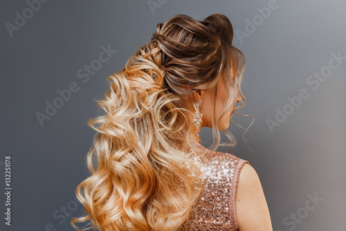 Rear view of a woman with dyed hair with a beautiful evening or wedding hairdo