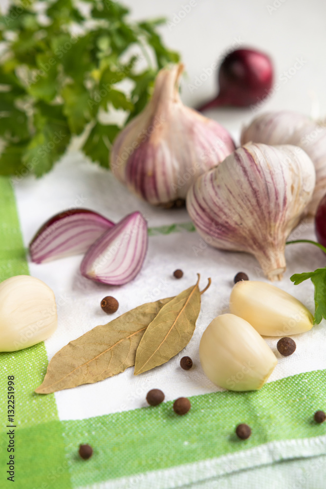 Fresh garlic, onion and spices on a light background closeup Fresh garlic, onion and spices on a light background closeup