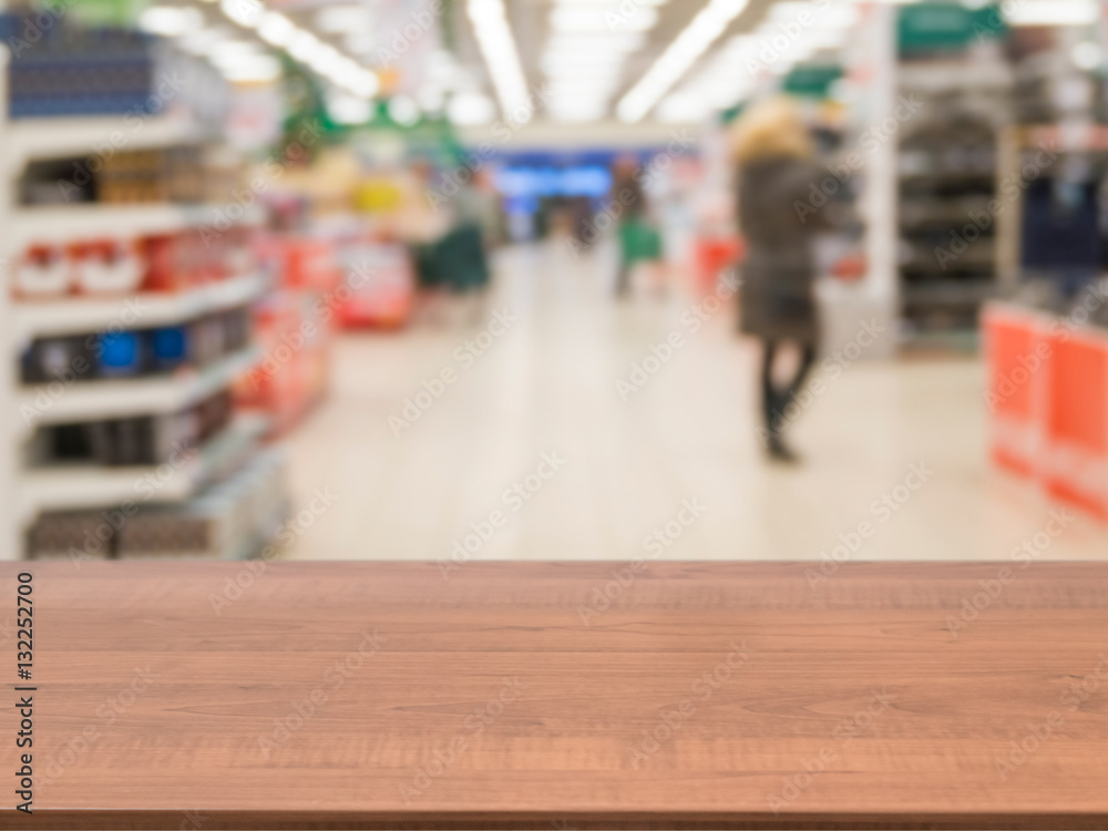 Wooden empty table in front of blurred supermarket