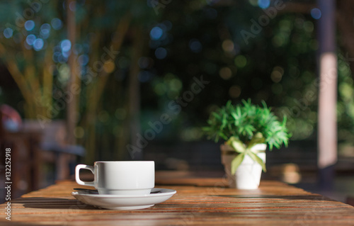 Cup of coffee on table on blured cafe background.