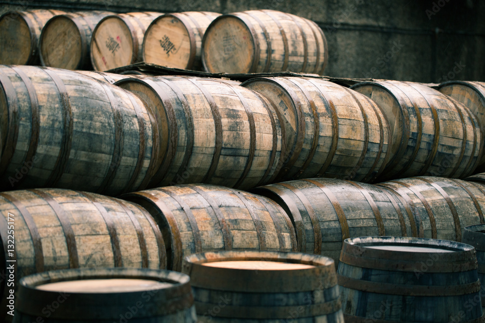 Whisky barrels full of whiskey in Scottish traditional distiller