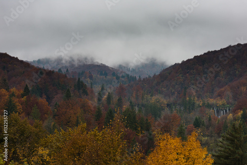 Landscape of Plitvice Lakes National Park. Foggy morning and colourful autumn forest.