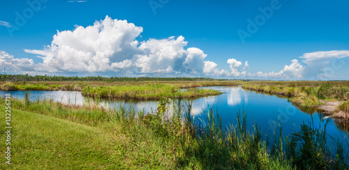 Panorama of canals in Gulf Shores State Park in Alabama USA with reflections of sky on water photo