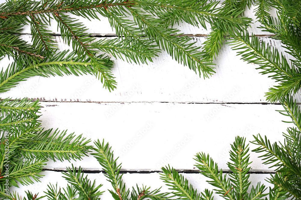 frame with spruce branches white wooden background frame with spruce branches white wooden background