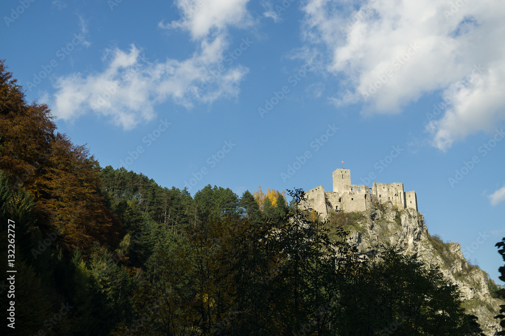 Castle on the rock in colorful woods during autumn. Slovakia
