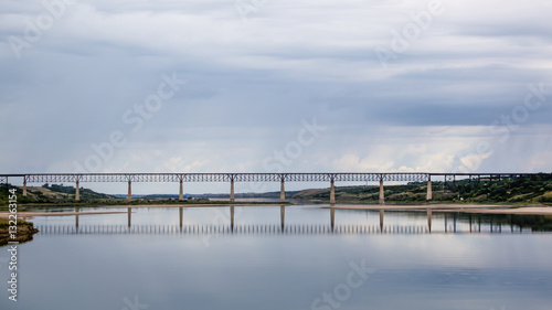 a long train bridge across a lake