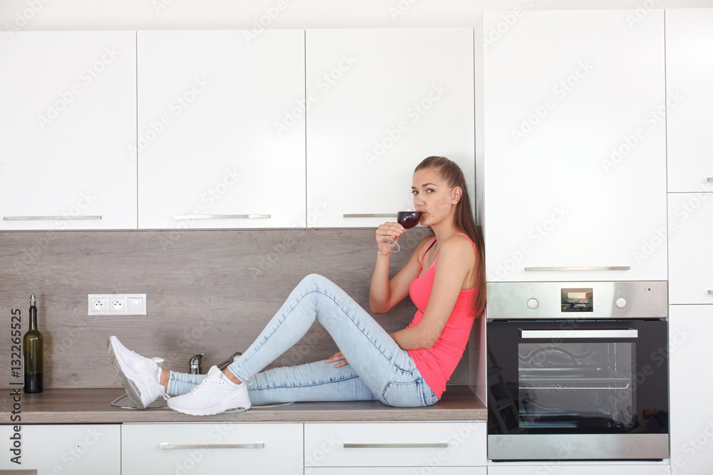 A young woman with a glass of wine. A young woman with a glass of wine.