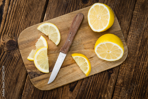 Lemon (sliced) on wooden background (selective focus)
