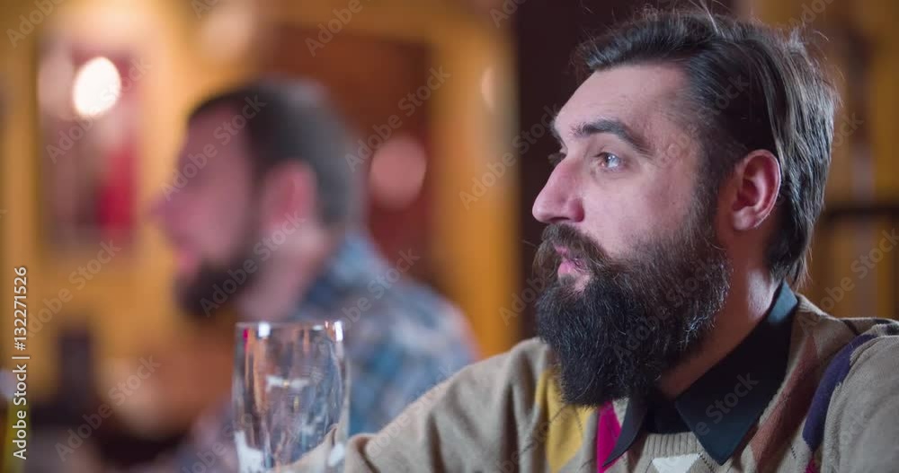 Men pub guests drinks beer at bar counter 4k refocus video. Male visitors taste lager, focus change between man clients