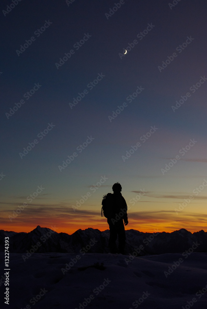 Hiker silhouette at sunset in Pramaggiore range, Friuli.