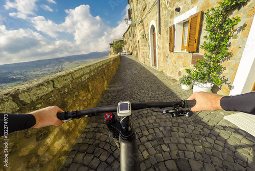 Going on bicycle in Umbria Orvieto tipical Italian town. Original point of view