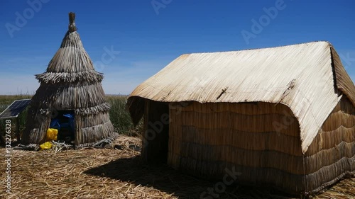 View of the Uros floating reed islands with boats, mysterious Lake Titicaca, Puno Region, Peru