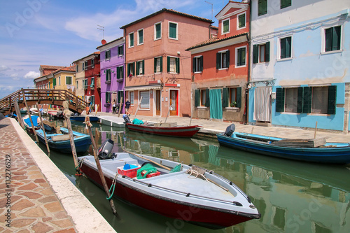 Colorful houses by canal in Burano, Venice, Italy.