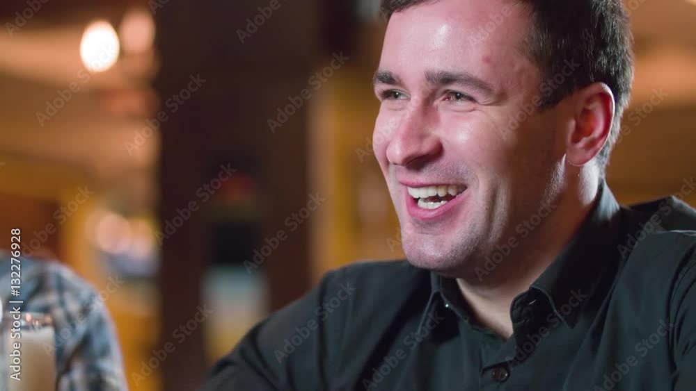 Man laughing and smiling at pub bar HD close-up slow-motion video. Having fun and leisure Man laughing and smiling at pub bar HD close-up slow-motion video. Having fun and leisure