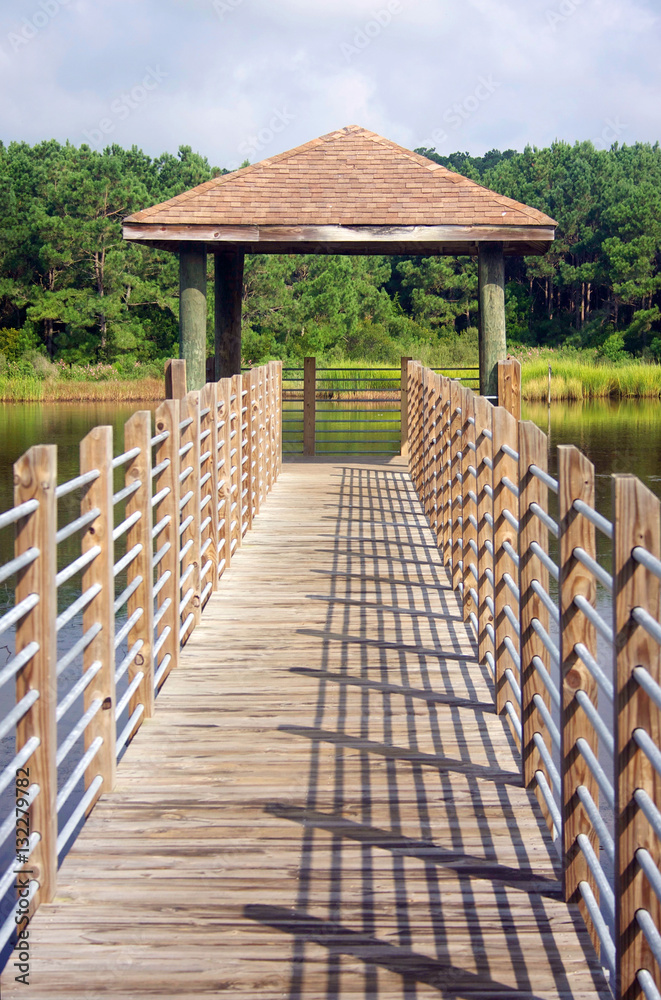 Huntington Beach State Park, South Carolina, USA. Wooden boardwalk and observation point in the expansive salt marsh, vertical composition. Huntington Beach State Park, South Carolina, USA. Wooden boardwalk and observation point in the expansive salt marsh, vertical composition.