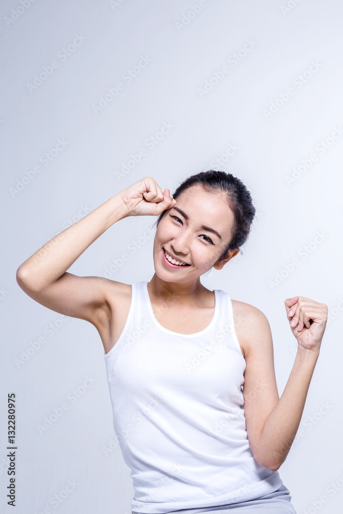 Beautiful brunette Asian girl in white tshirt stretching, relaxi Beautiful brunette Asian girl in white tshirt stretching, relaxi