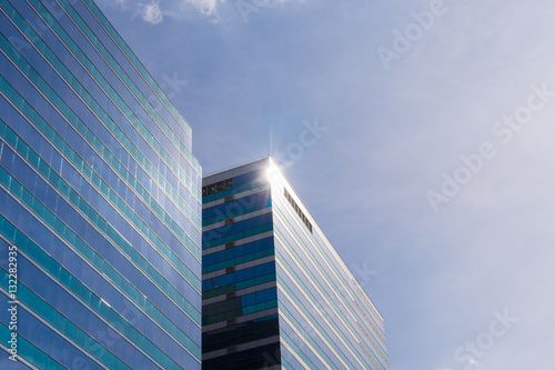 Glass office building with blue sky