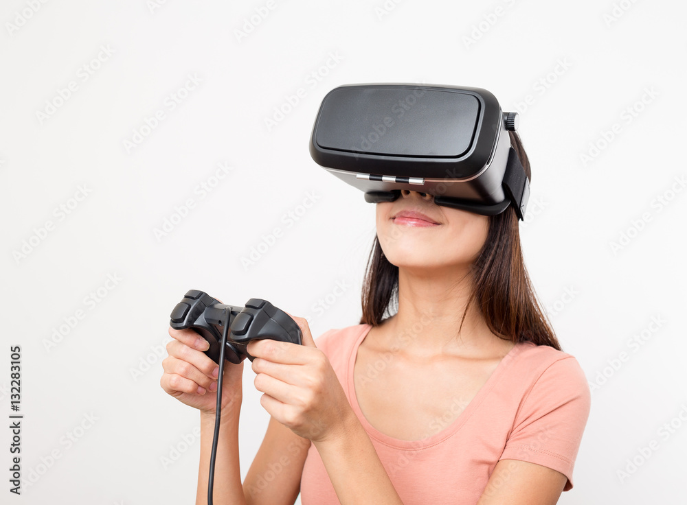 Woman looking though the virtual reality and using joystick Woman looking though the virtual reality and using joystick